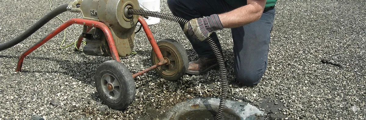 sewer rodding technician actively removing blockages from a sewer line in Columbia, SC